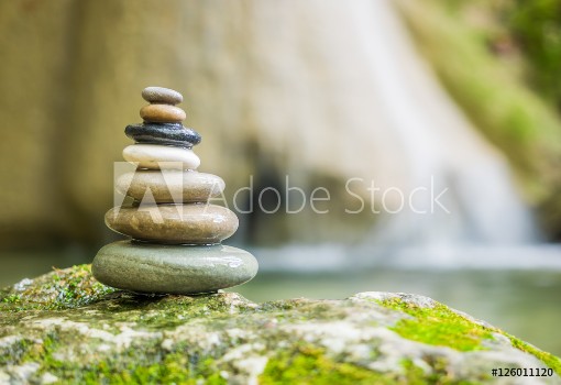 Bild på Rock Zen Stack pile of stones in front of waterfall